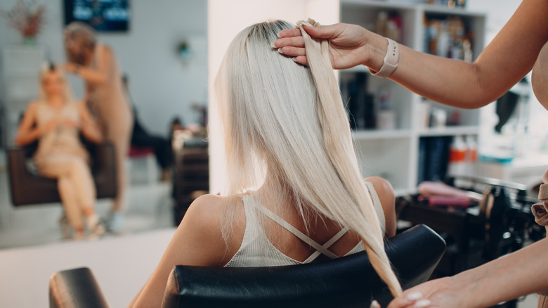 woman having extensions color-matched