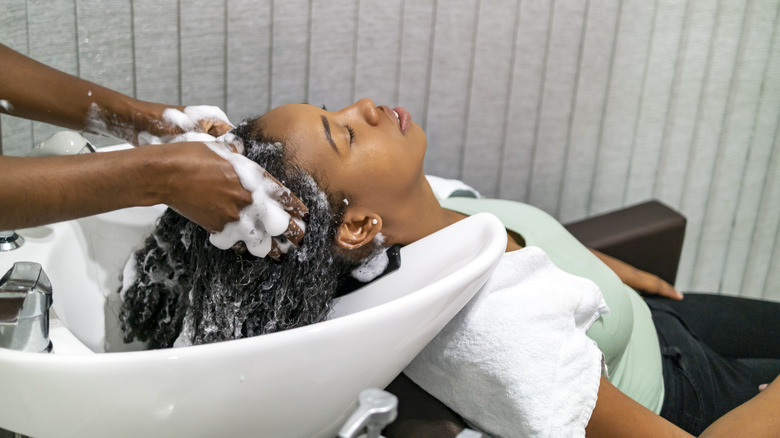 client having hair washed 