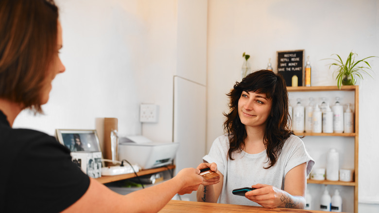 Woman paying for her services at a salon