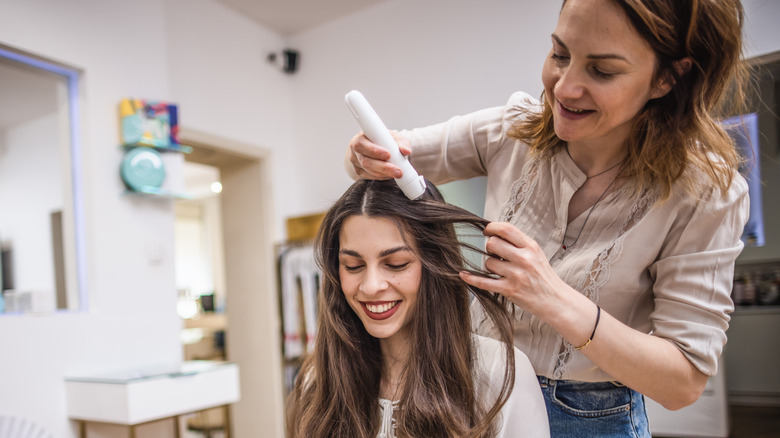 Woman smiling at a hair salon