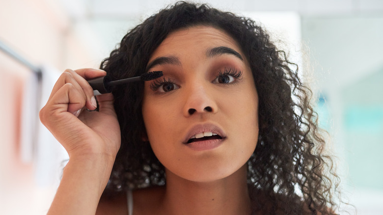 Woman applying mascara