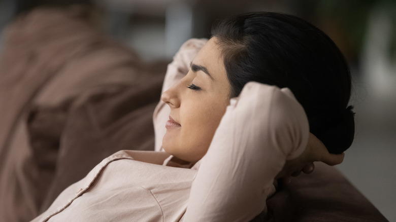 Smiling woman meditating or relaxing