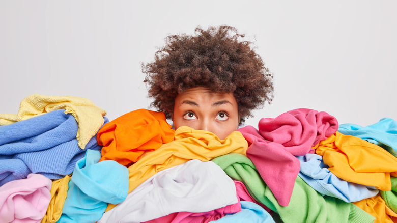 woman surrounded by clothes