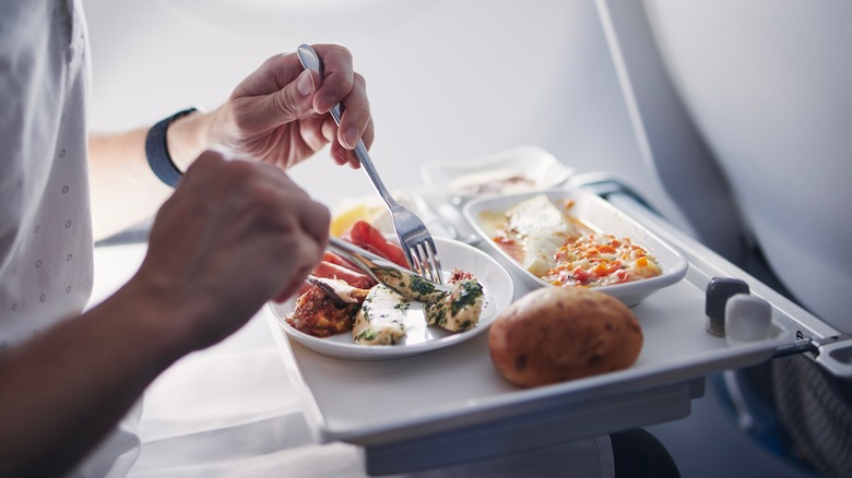 man eating airplane food