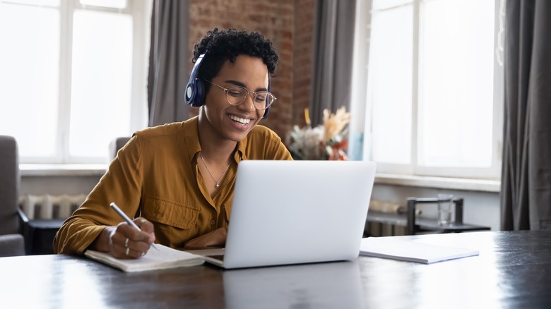 Woman excitedly sitting at computer