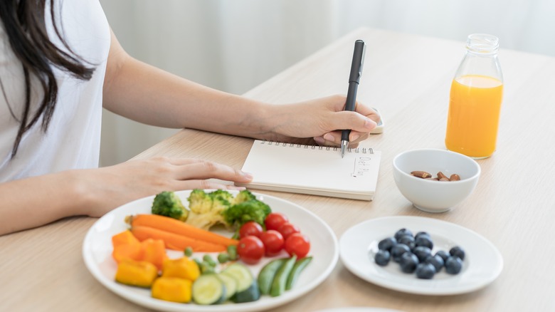 eating healthy food with notebook