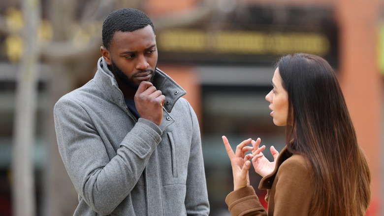 Man and woman speaking outside