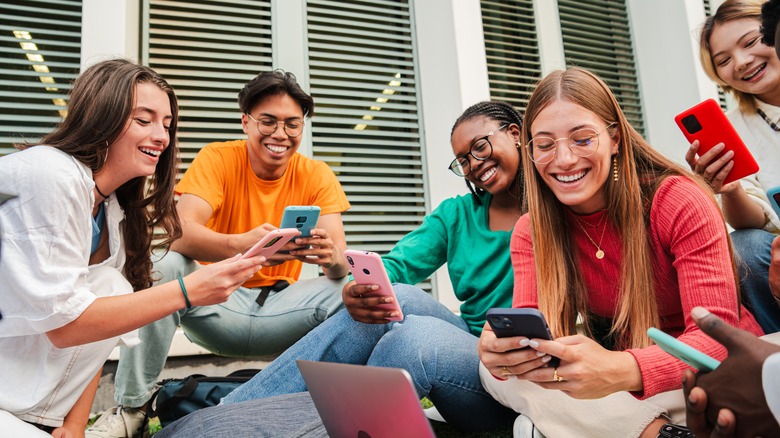 Young people using phones together