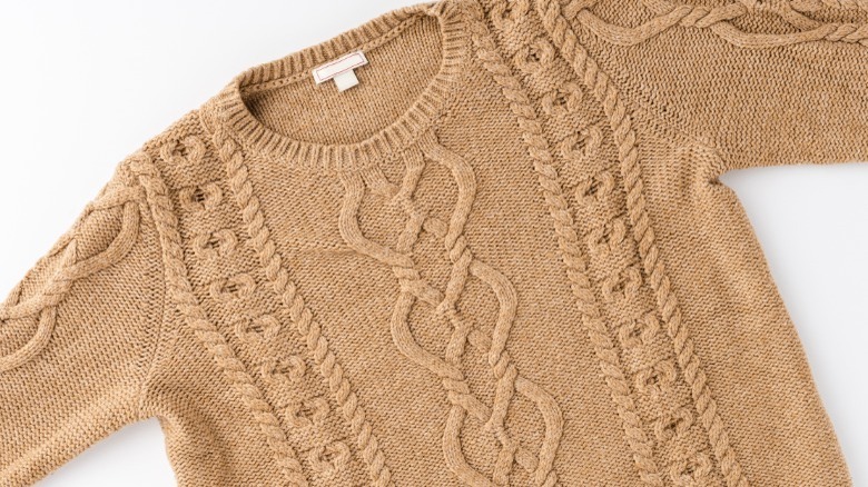 Beige wool sweater laid out