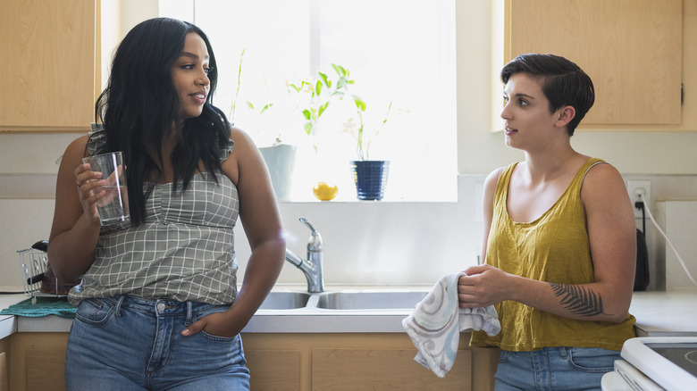 Two people talking in a kitchen