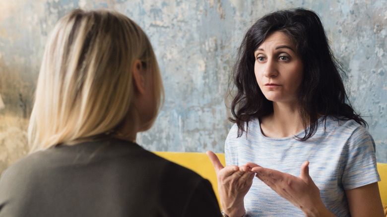 Two women having a serious conversation.