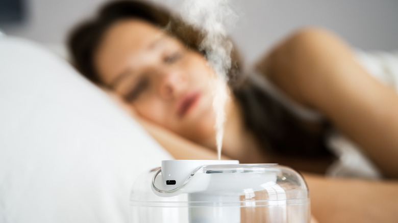 Woman sleeping near humidifier