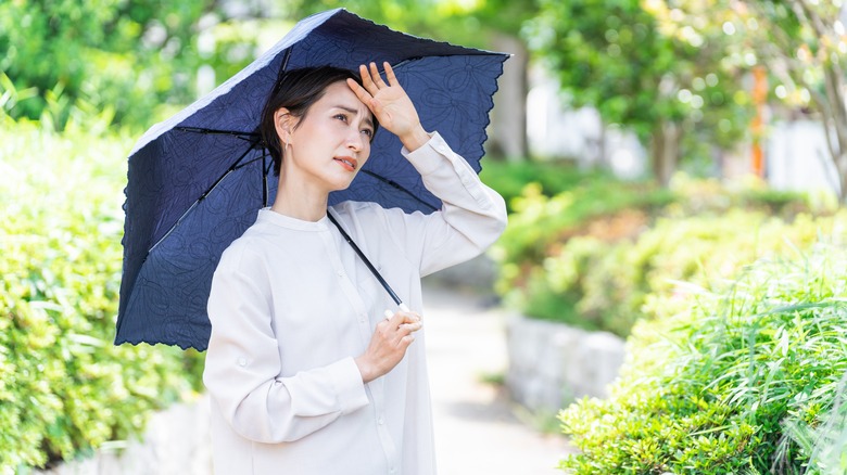 Woman holding umbrella outside