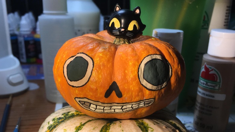 Miniature painted pumpkin and black cat