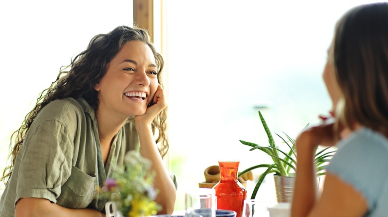 Happy women talking at restaurant