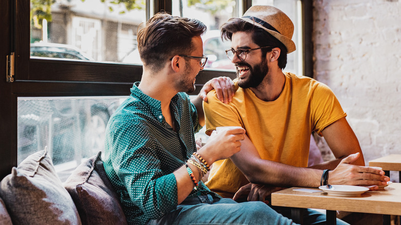 Couple laughing at cafe