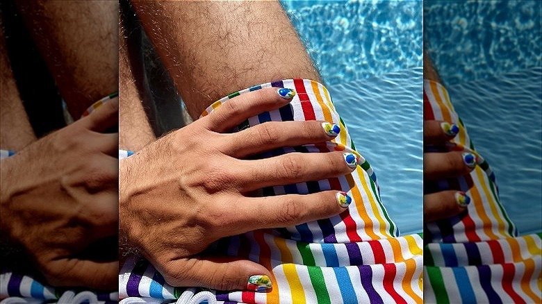 hands with multicolored mismatched manicure