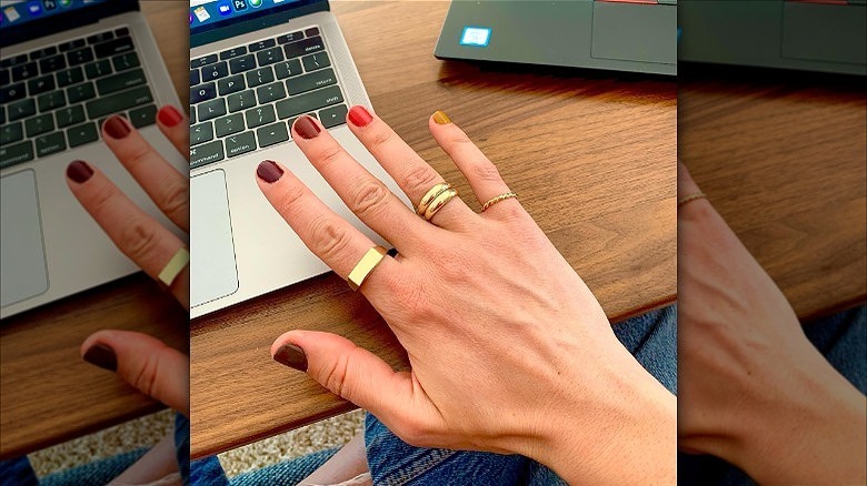 hand with mismatched fall manicure