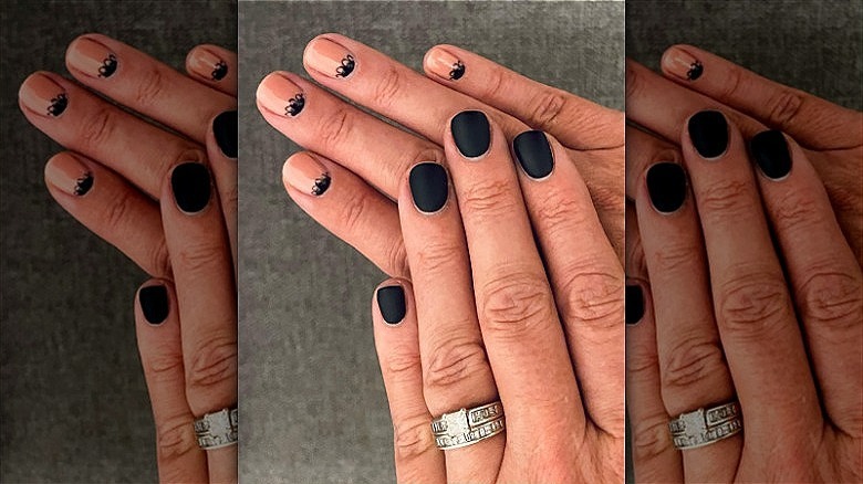 woman's hands with mismatched manicure