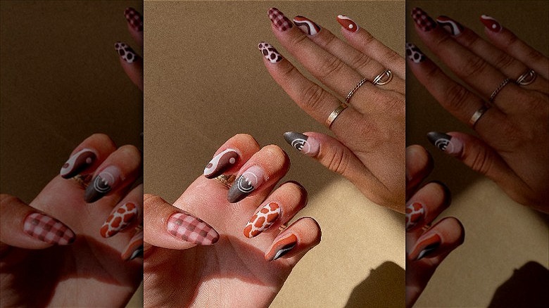 hands with brown mismatched nails