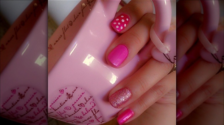 hand with mismatched barbie pink mani