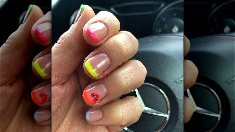 hands with mismatched french manicure