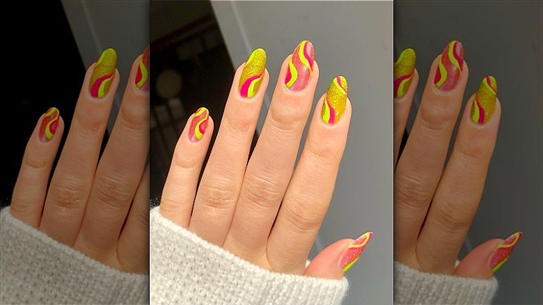 woman with mismatched neon manicure