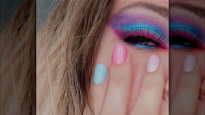 hand with mismatched pastel nails