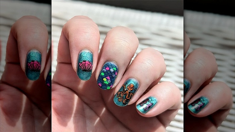 hand with ocean mismatched nails
