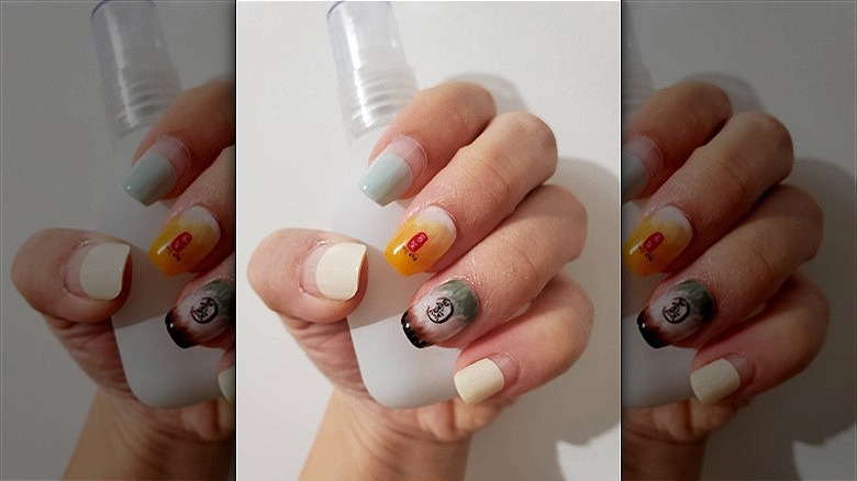 woman's hands with mismatched nails