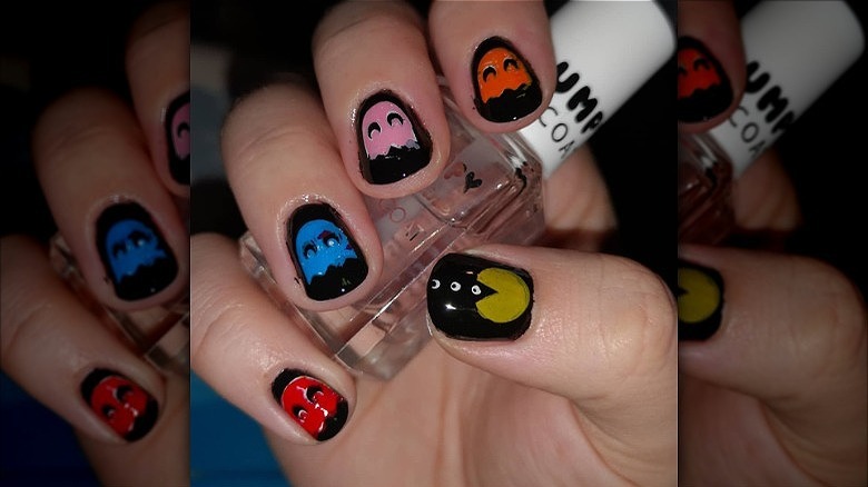 hand with pac man mismatched manicure