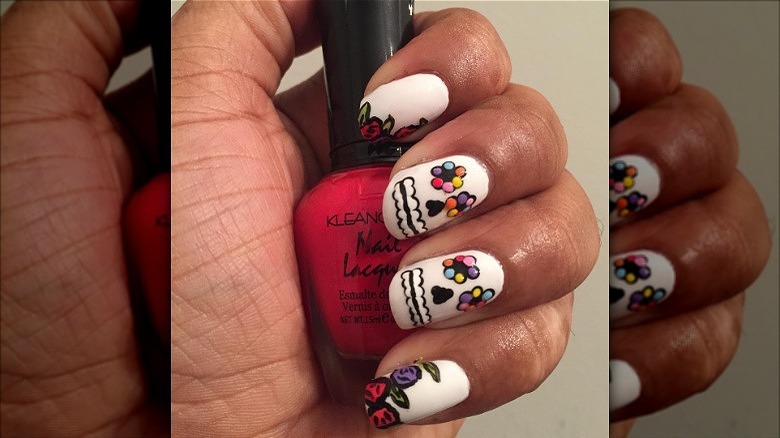 hand with dia de los muertos nails