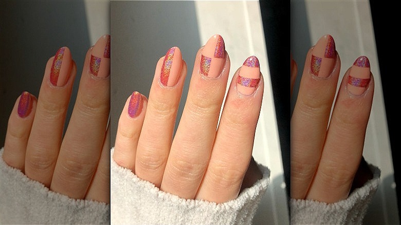 woman with mismatched glitter manicure