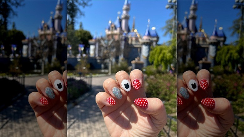 hand with mismatched disney nails