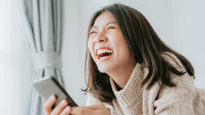 laughing woman texting