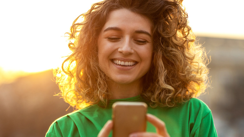 laughing woman texting