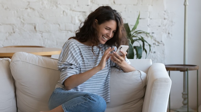 laughing woman texting