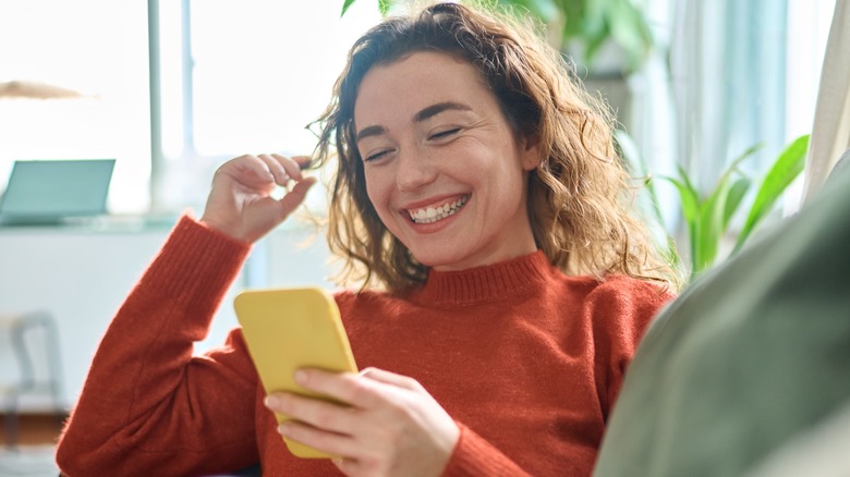 laughing texting woman