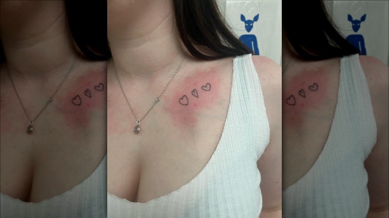 woman with hearts collarbone tattoo