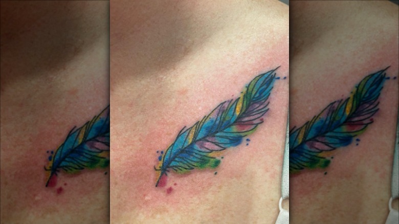 colorful feather collarbone tattoo