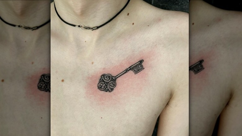 ornate key collarbone tattoo