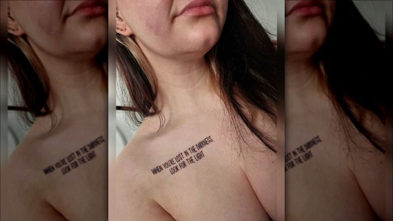 woman with quote collarbone tattoo