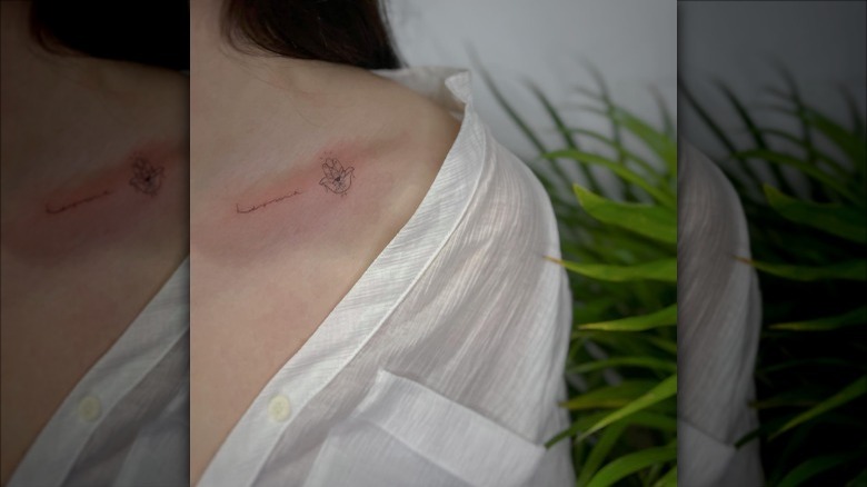 woman with fine-line collarbone tattoo