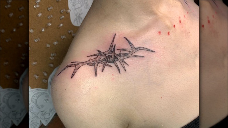 woman with thorns collarbone tattoo