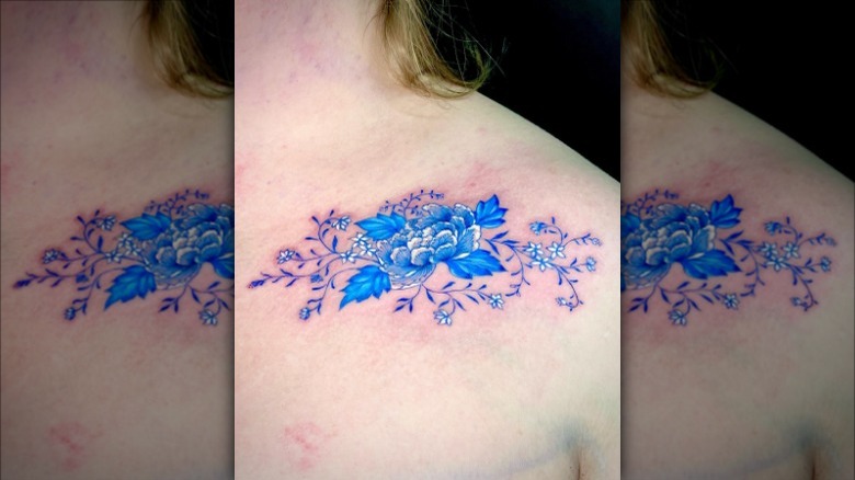 blue flower collarbone tattoo