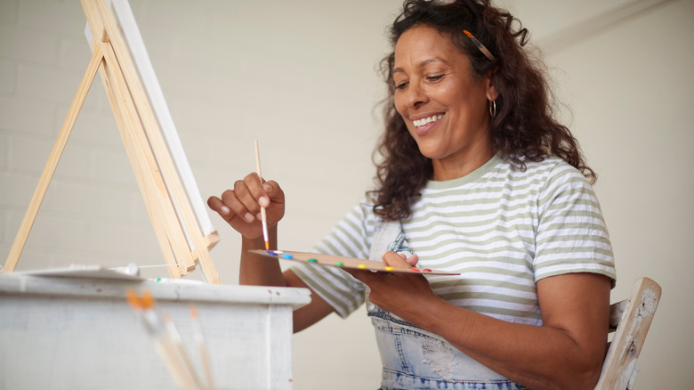 woman painting and smiling