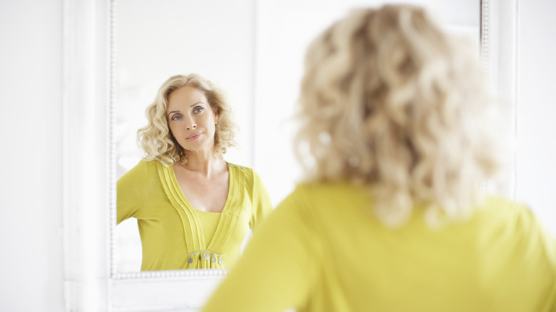 woman looking in mirror