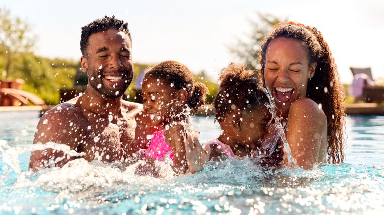 family in pool smiling