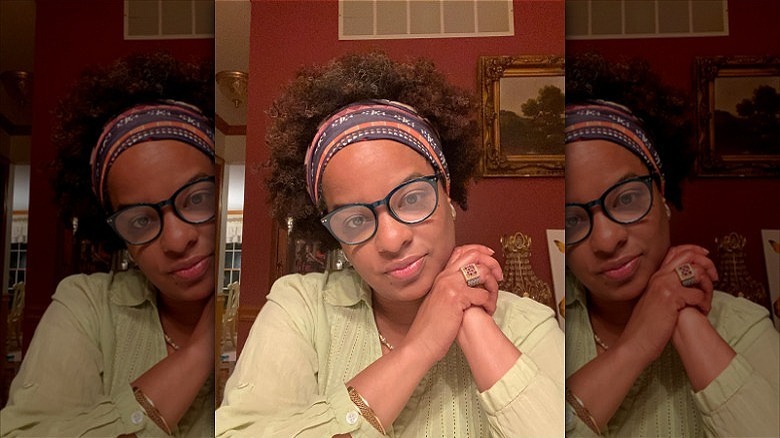 woman with short curly hair in headband