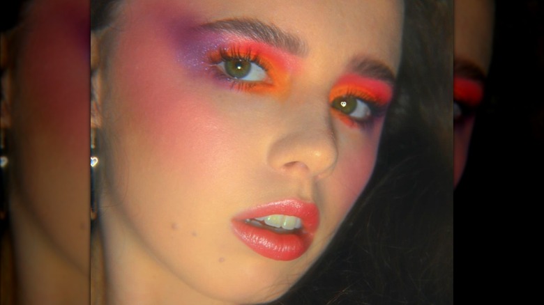 Woman wearing neon eye makeup